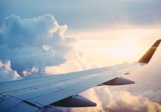 View of an airplane wing during flight, symbolizing travel assistance for veterans receiving care at Solara Mental Health.