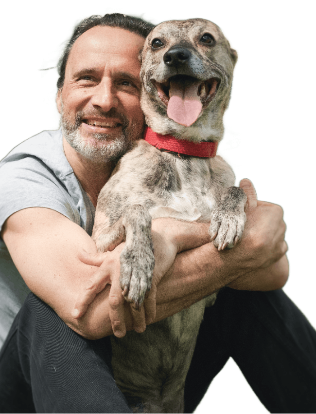 A veteran hugging his joyful dog, emphasizing the bond between veterans and their pets, and the importance of bringing pets along for emotional support during treatment at Solara Mental Health’s pet-friendly facility.